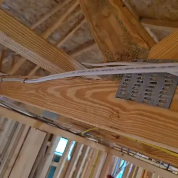 New construction rough-in wiring run along the framing